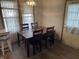 Inviting dining room featuring a wooden table set for four, natural light, and vinyl flooring at 1835 Carpenter Cir, Indianapolis, IN 46203