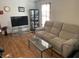 Comfortable living room showcasing a plush sofa, modern TV stand, and stylish glass coffee table at 1835 Carpenter Cir, Indianapolis, IN 46203