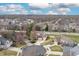 An aerial view shows a residential neighborhood with tree-lined streets and well-maintained lawns at 18358 Benton Oak Dr, Noblesville, IN 46062