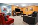 Spacious basement with bright accent walls, two seating areas, and a large TV for entertainment at 18358 Benton Oak Dr, Noblesville, IN 46062