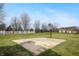 On a grassy lawn sits a basketball court with a hoop, surrounded by a white picket fence at 18358 Benton Oak Dr, Noblesville, IN 46062
