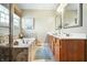Luxurious bathroom features soaking tub with stone tile surround, window, and double sink vanity at 18358 Benton Oak Dr, Noblesville, IN 46062