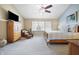 Comfortable bedroom featuring vaulted ceiling, ceiling fan, plush carpet, and decorative wood furniture at 18358 Benton Oak Dr, Noblesville, IN 46062