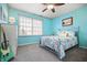 Bright bedroom featuring a full-sized bed, bedside table, guitar, closet, and natural light at 18358 Benton Oak Dr, Noblesville, IN 46062