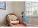 Cozy bedroom nook with wicker chair, accent pillows, colorful table, and natural light at 18358 Benton Oak Dr, Noblesville, IN 46062