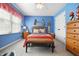 Bright bedroom with blue walls, woven furniture, and decorative surfboards for a unique touch at 18358 Benton Oak Dr, Noblesville, IN 46062