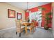 Bright dining room with a vibrant accent wall, stylish lighting, and seating for a cozy atmosphere at 18358 Benton Oak Dr, Noblesville, IN 46062