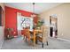 Charming dining room with a vibrant accent wall, stylish lighting, and seating for a cozy atmosphere at 18358 Benton Oak Dr, Noblesville, IN 46062