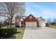 Charming two-story home featuring a brick facade, attached two-car garage, and well-manicured lawn at 18358 Benton Oak Dr, Noblesville, IN 46062