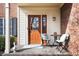 Inviting front porch with seating, perfect for relaxing and enjoying the outdoors with a brick wall at 18358 Benton Oak Dr, Noblesville, IN 46062