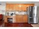 Spacious kitchen featuring stainless steel appliances, granite counters, and hardwood floor at 18358 Benton Oak Dr, Noblesville, IN 46062