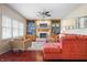 Inviting living room with fireplace, built-in shelving, ceiling fan and hardwood floor at 18358 Benton Oak Dr, Noblesville, IN 46062