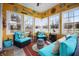 Bright and sunny sunroom with multiple seating areas, decorative accents, and large windows at 18358 Benton Oak Dr, Noblesville, IN 46062