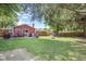 Large backyard featuring a patio, fire pit, shed, and mature trees at 1906 E Markwood Ave, Indianapolis, IN 46227
