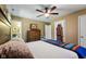 Cozy bedroom featuring a ceiling fan, a dresser, closet, and an ensuite bathroom at 1906 E Markwood Ave, Indianapolis, IN 46227