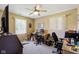 Bedroom with a ceiling fan, light colored walls, a desk, and two windows at 1906 E Markwood Ave, Indianapolis, IN 46227