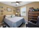 Comfortable bedroom with natural light, a ceiling fan, and cozy furnishings creating a relaxing atmosphere at 1906 E Markwood Ave, Indianapolis, IN 46227