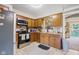 Traditional kitchen with wood cabinets, stainless steel appliances, tile backsplash, and neutral countertops at 1906 E Markwood Ave, Indianapolis, IN 46227
