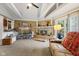 Spacious living room with a fireplace, beamed ceilings, and sliding glass doors to the outdoor space at 1906 E Markwood Ave, Indianapolis, IN 46227