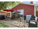 Back patio with a table and chairs, a grill, and red-colored home exterior at 1906 E Markwood Ave, Indianapolis, IN 46227