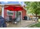 Outdoor patio with an umbrella, table and chairs, and a grill at 1906 E Markwood Ave, Indianapolis, IN 46227