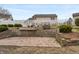 This backyard features a patio with a retaining wall and partial lake views at 1975 Westminster Pl, Columbus, IN 47201