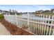 This backyard features a vinyl fence and a partial view of the lake at 1975 Westminster Pl, Columbus, IN 47201