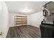 This basement features vinyl plank flooring and utility shelving, with utilities in the corner at 1975 Westminster Pl, Columbus, IN 47201
