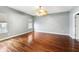 Spacious bedroom with a ceiling fan, windows, and hardwood floors at 1975 Westminster Pl, Columbus, IN 47201