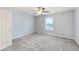 This bedroom features neutral walls, carpet, a ceiling fan with lighting, and a window at 1975 Westminster Pl, Columbus, IN 47201