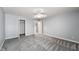A comfortable bedroom with neutral carpet, ceiling fan, and ample closet space at 1975 Westminster Pl, Columbus, IN 47201