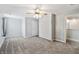 This bedroom features a built-in Murphy bed, neutral walls and carpet, and a ceiling fan with lighting at 1975 Westminster Pl, Columbus, IN 47201