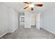 This bedroom features neutral walls and carpet, a ceiling fan with lighting, a closet, and an open doorway at 1975 Westminster Pl, Columbus, IN 47201