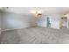 A large bonus room with neutral walls and carpet is perfect for entertaining or relaxing at 1975 Westminster Pl, Columbus, IN 47201