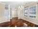 Elegant dining room featuring hardwood floors, a stylish chandelier, and bright natural light from large windows at 1975 Westminster Pl, Columbus, IN 47201