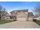 Inviting two-story home with a brick-accented facade, attached three-car garage, and a charming covered porch at 1975 Westminster Pl, Columbus, IN 47201