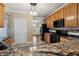 Contemporary kitchen with granite counters, wood cabinets, and stainless appliances at 1975 Westminster Pl, Columbus, IN 47201