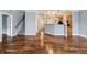 Open-concept living space with hardwood floors, connecting to the kitchen and staircase, offering versatile living at 1975 Westminster Pl, Columbus, IN 47201