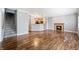 Open-concept living room with hardwood floors, a fireplace, and staircase access, adjoining the kitchen area at 1975 Westminster Pl, Columbus, IN 47201