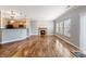 Spacious living room featuring hardwood floors, a cozy fireplace, and a view of the kitchen's breakfast bar at 1975 Westminster Pl, Columbus, IN 47201