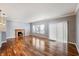 Bright, airy living room with hardwood floors, a fireplace, and large windows, perfect for relaxation and gatherings at 1975 Westminster Pl, Columbus, IN 47201
