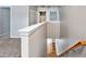 A staircase with a wooden railing and carpeted steps leads to the upper level at 1975 Westminster Pl, Columbus, IN 47201