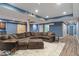 Finished basement with a large sectional sofa, light blue walls, sliding barn doors, and recessed lighting at 2091 Banburry Pl, Avon, IN 46123