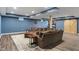 Basement area with gray sofa, bar area, and wood-look flooring at 2091 Banburry Pl, Avon, IN 46123
