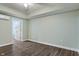 Bedroom with light green walls and dark wood floor at 2091 Banburry Pl, Avon, IN 46123