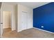 Bedroom featuring neutral carpet, a blue accent wall, and a closet with sliding doors at 2091 Banburry Pl, Avon, IN 46123