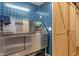 Dog washing station with stainless steel tub, blue tile and sliding barn door at 2091 Banburry Pl, Avon, IN 46123