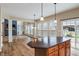 Open-concept kitchen and living space with a fireplace and access to the backyard at 2091 Banburry Pl, Avon, IN 46123