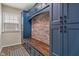 Chic mudroom with custom blue cabinetry, a bench, and a brick accent wall at 2091 Banburry Pl, Avon, IN 46123
