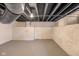 Unfinished basement with exposed ceiling and painted brick walls, offering a blank canvas at 2155 S Delaware St, Indianapolis, IN 46225